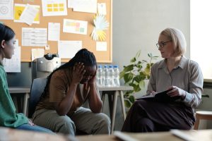 A therapist providing anxiety and depression treatment to a female client in Louisville KY, during a calm and supportive counseling session.