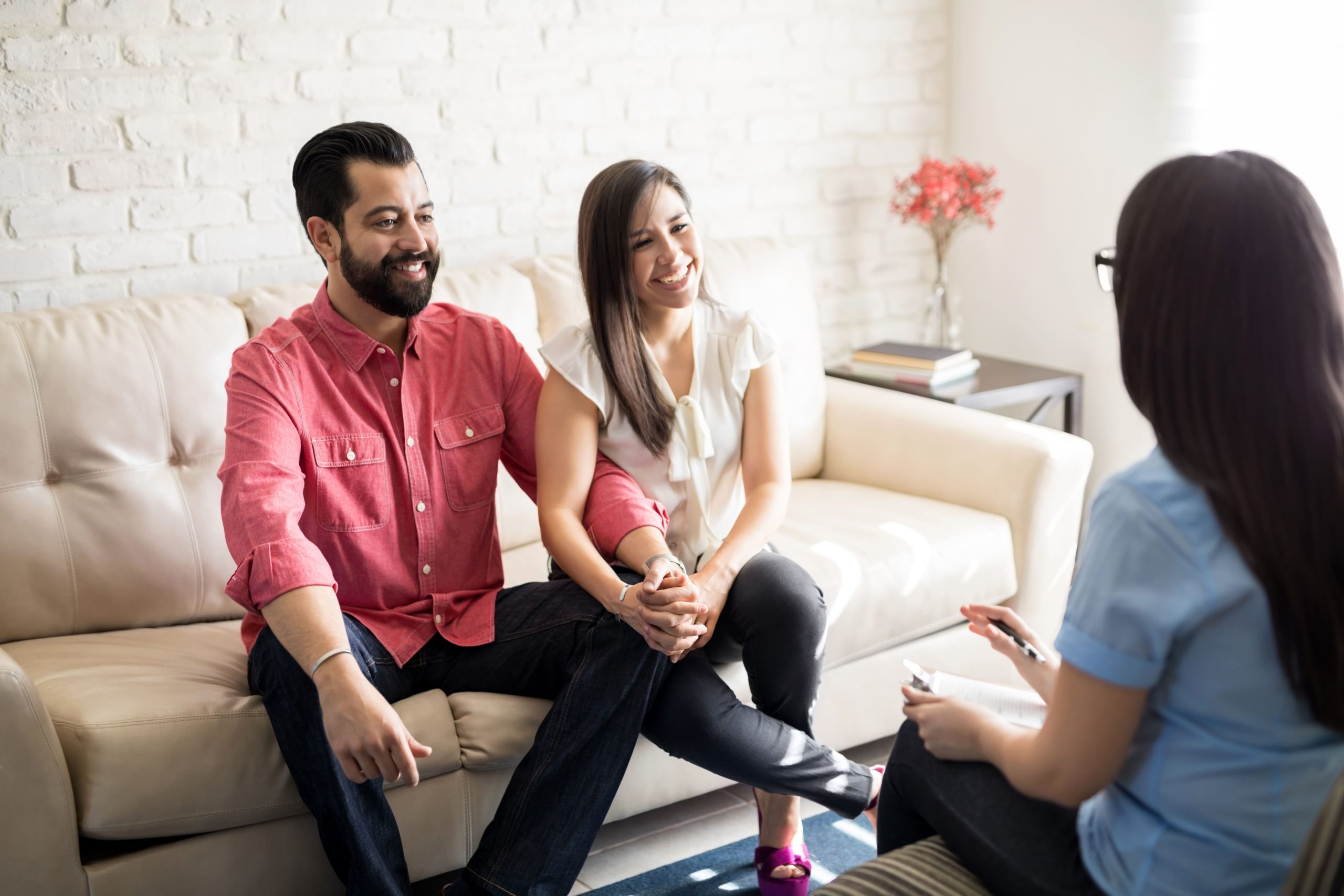 A family sits with a therapist during a counseling session in a warm, welcoming office.